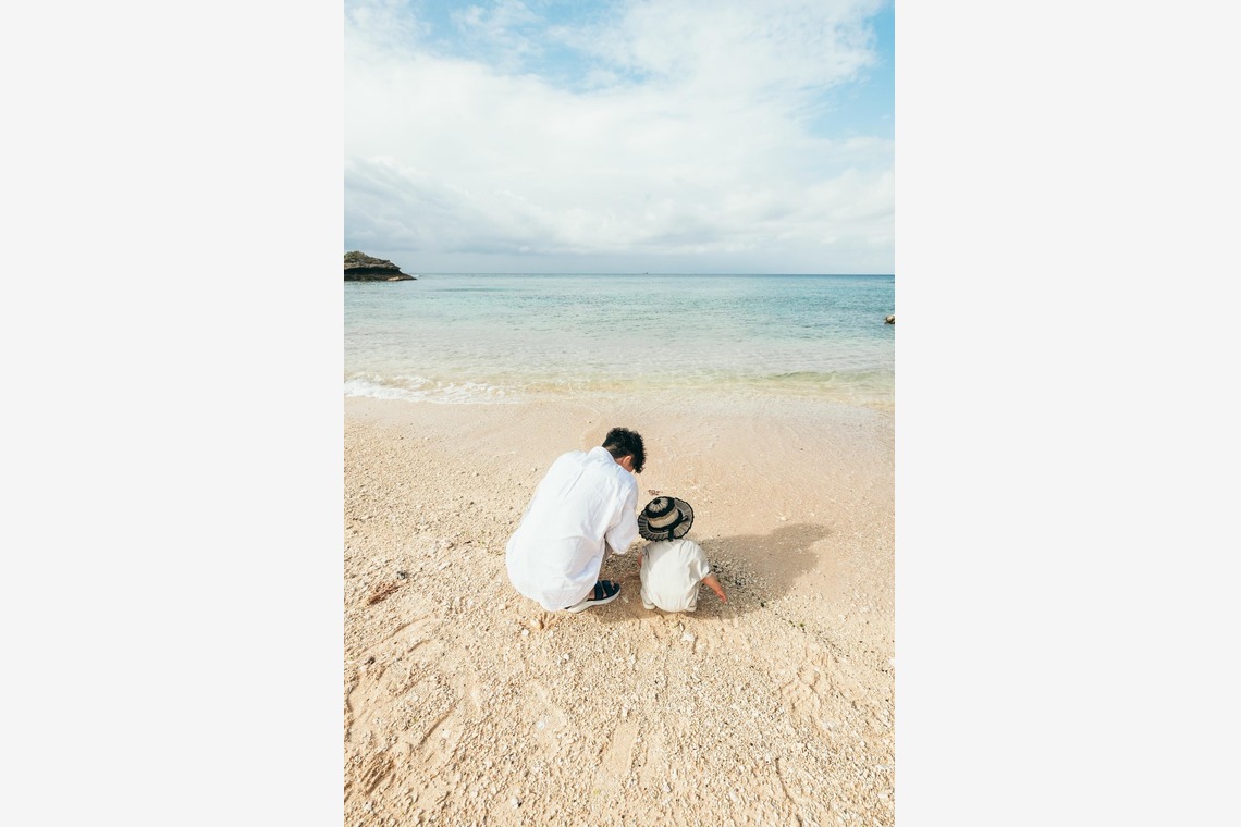 ポートレート沖縄が出張撮影した家族写真(キッズ,ベビーフォト)などが写った「自然の中の家族の自然な姿＠読谷村の海岸と芝生」の家族写真